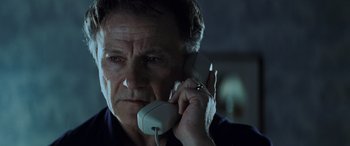 Movie still from “Red Dragon” (2002), directed by Brett Ratner – An older man holding a phone up to his ear; Close Up shot, Low angle