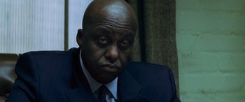 Movie still from “Red Dragon” (2002), directed by Brett Ratner – A man in a suit and tie looking sad; Close Up shot, Low angle