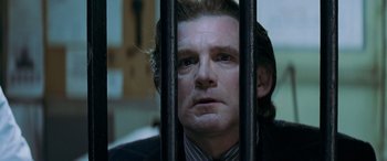 Movie still from “Red Dragon” (2002), directed by Brett Ratner – A person behind a fence; Close Up shot, Low angle