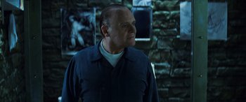 Movie still from “Red Dragon” (2002), directed by Brett Ratner – An older man standing in front of a brick wall; Close Up shot, Over the shoulder angle