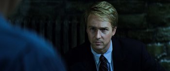 Movie still from “Red Dragon” (2002), directed by Brett Ratner – A person wearing a suit and tie; Close Up shot, Over the shoulder angle