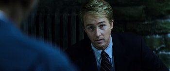 Movie still from “Red Dragon” (2002), directed by Brett Ratner – A person wearing a suit and tie; Close Up shot, Over the shoulder angle