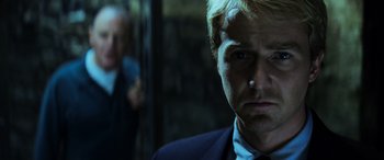 Movie still from “Red Dragon” (2002), directed by Brett Ratner – A person wearing a suit and tie; Close Up shot, Low angle