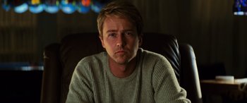 Movie still from “Red Dragon” (2002), directed by Brett Ratner – A person sitting in a chair; Close Up shot, Low angle