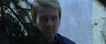 Movie still from “Red Dragon” (2002), directed by Brett Ratner – A person wearing a jacket near a tree; Close Up shot, Over the shoulder angle