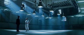 Movie still from “Red Dragon” (2002), directed by Brett Ratner – A man holding a baseball bat inside of a building; Wide shot, Low angle