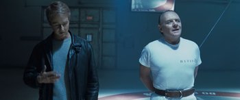 Movie still from “Red Dragon” (2002), directed by Brett Ratner – Two men standing next to each other in a dark room; Medium shot, Over the shoulder angle