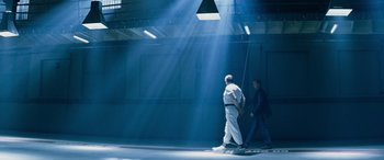 Movie still from “Red Dragon” (2002), directed by Brett Ratner – Two people are walking in the light of a building; Extreme Wide shot, Low angle