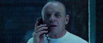 Movie still from “Red Dragon” (2002), directed by Brett Ratner – An older man holding a phone up to his ear; Close Up shot, Low angle