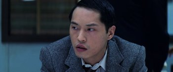 Movie still from “Red Dragon” (2002), directed by Brett Ratner – A person wearing a suit and tie; Close Up shot, High angle