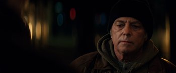 Movie still from “Red Dragon” (2002), directed by Brett Ratner – A person wearing a jacket and a hat; Close Up shot, Over the shoulder angle