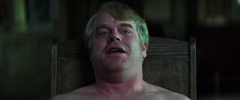 Movie still from “Red Dragon” (2002), directed by Brett Ratner – A person laying on a chair; Close Up shot, Low angle