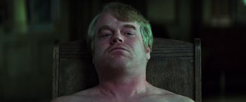 Movie still from “Red Dragon” (2002), directed by Brett Ratner – A person laying on a chair; Close Up shot, Low angle