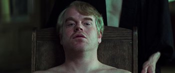 Movie still from “Red Dragon” (2002), directed by Brett Ratner – A person with a beard; Close Up shot, Overhead angle