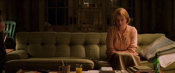 Movie still from “Red Dragon” (2002), directed by Brett Ratner – A woman sitting on top of a couch in a living room; Medium shot, Over the shoulder angle