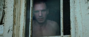 Movie still from “Red Dragon” (2002), directed by Brett Ratner – A man looking out of a window in the rain; Close Up shot, Low angle