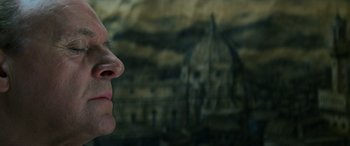 Movie still from “Red Dragon” (2002), directed by Brett Ratner – A person's face with a building in the background; Close Up shot, Low angle