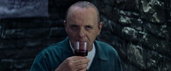 Movie still from “Red Dragon” (2002), directed by Brett Ratner – A man holding a glass of wine in his hand; Close Up shot, Low angle
