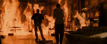Movie still from “Red Dragon” (2002), directed by Brett Ratner – Two people are standing in front of a fire; Wide shot, High angle
