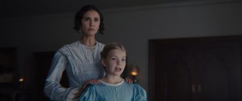 Movie still from “Redeeming Love” (2022), directed by D.J. Caruso – A woman and a young girl standing next to each other in a room; Medium shot, Over the shoulder angle