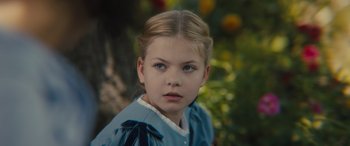 Movie still from “Redeeming Love” (2022), directed by D.J. Caruso – A young girl in a blue dress looking at the camera; Close Up shot, High angle