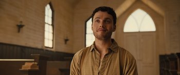 Movie still from “Redeeming Love” (2022), directed by D.J. Caruso – A man in a brown shirt is standing in front of a window; Close Up shot, Low angle