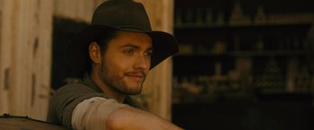 Movie still from “Redeeming Love” (2022), directed by D.J. Caruso – A person wearing a hat; Close Up shot, Over the shoulder angle