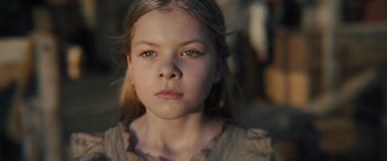 Movie still from “Redeeming Love” (2022), directed by D.J. Caruso – A young girl is looking into the camera; Close Up shot, Low angle
