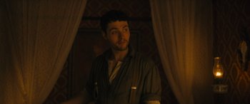 Movie still from “Redeeming Love” (2022), directed by D.J. Caruso – A man standing in a room with a curtain; Medium shot, Low angle