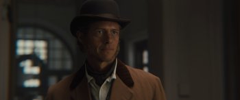 Movie still from “Redeeming Love” (2022), directed by D.J. Caruso – A man wearing a hat and a brown jacket; Close Up shot, Low angle