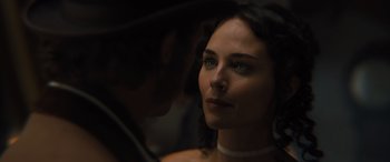 Movie still from “Redeeming Love” (2022), directed by D.J. Caruso – A beautiful woman looking at the camera while wearing a pearl necklace; Close Up shot, Over the shoulder angle