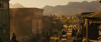 Movie still from “Redeeming Love” (2022), directed by D.J. Caruso – An image of an old western town with horses and carriages; Extreme Wide shot, High angle