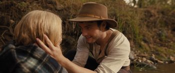 Movie still from “Redeeming Love” (2022), directed by D.J. Caruso – A young man wearing a brown hat talking to a woman; Close Up shot, Over the shoulder angle