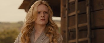 Movie still from “Redeeming Love” (2022), directed by D.J. Caruso – A woman with long blonde wavy hair looking to her left; Close Up shot, Over the shoulder angle