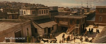 Movie still from “Redeeming Love” (2022), directed by D.J. Caruso – A group of people standing on top of a dirt road; Extreme Wide shot, High angle