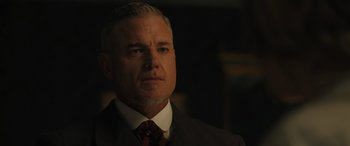 Movie still from “Redeeming Love” (2022), directed by D.J. Caruso – A person wearing a suit and tie; Close Up shot, Low angle