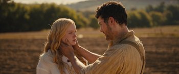Movie still from “Redeeming Love” (2022), directed by D.J. Caruso – A man is touching a woman's face with his hands; Close Up shot, Over the shoulder angle