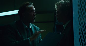 Movie still from “Bad Lieutenant: Port of Call New Orleans” (2009), directed by Werner Herzog – Two men in business suits talking to each other; Medium shot, Over the shoulder angle