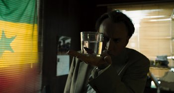 Movie still from “Bad Lieutenant: Port of Call New Orleans” (2009), directed by Werner Herzog – A person holding a glass of water in their hand; Close Up shot, Low angle