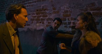 Movie still from “Bad Lieutenant: Port of Call New Orleans” (2009), directed by Werner Herzog – A group of people standing next to a brick wall; Medium shot, Over the shoulder angle
