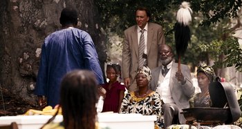 Movie still from “Bad Lieutenant: Port of Call New Orleans” (2009), directed by Werner Herzog – A group of people sitting around a tree; Medium shot, Over the shoulder angle