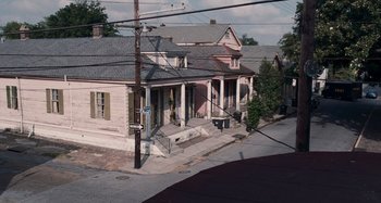 Movie still from “Bad Lieutenant: Port of Call New Orleans” (2009), directed by Werner Herzog – An image of a street scene with a house on the side of the road; Extreme Wide shot, High angle