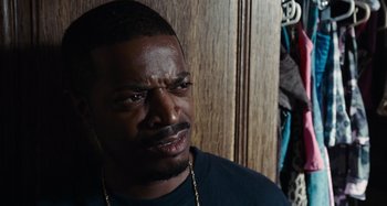 Movie still from “Bad Lieutenant: Port of Call New Orleans” (2009), directed by Werner Herzog – A person wearing a black shirt; Close Up shot, Over the shoulder angle