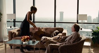 Movie still from “Bad Lieutenant: Port of Call New Orleans” (2009), directed by Werner Herzog – A man and a woman sitting in a living room with a dog; Wide shot, Over the shoulder angle