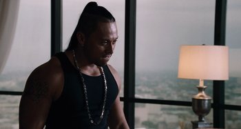 Movie still from “Bad Lieutenant: Port of Call New Orleans” (2009), directed by Werner Herzog – A man with long black hair wearing a black tank top; Close Up shot, Over the shoulder angle