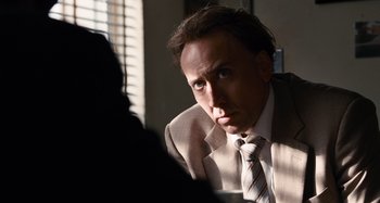 Movie still from “Bad Lieutenant: Port of Call New Orleans” (2009), directed by Werner Herzog – A person wearing a suit and a tie; Close Up shot, Over the shoulder angle