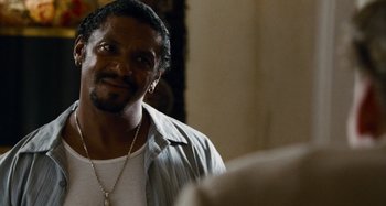 Movie still from “Bad Lieutenant: Port of Call New Orleans” (2009), directed by Werner Herzog – A person with a beard; Close Up shot, Over the shoulder angle