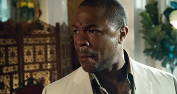 Movie still from “Bad Lieutenant: Port of Call New Orleans” (2009), directed by Werner Herzog – A person wearing a suit and tie; Close Up shot, Over the shoulder angle