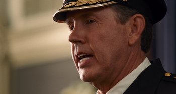 Movie still from “Bad Lieutenant: Port of Call New Orleans” (2009), directed by Werner Herzog – A person wearing a hat; Close Up shot, Over the shoulder angle