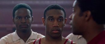 Movie still from “Remember the Titans” (2000), directed by Boaz Yakin – A person wearing a tank top; Close Up shot, Over the shoulder angle